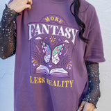 A purple t-shirt More Fantasy Less Reality, with a bookish graphic, Fantasy Romance merch, Gift for readers