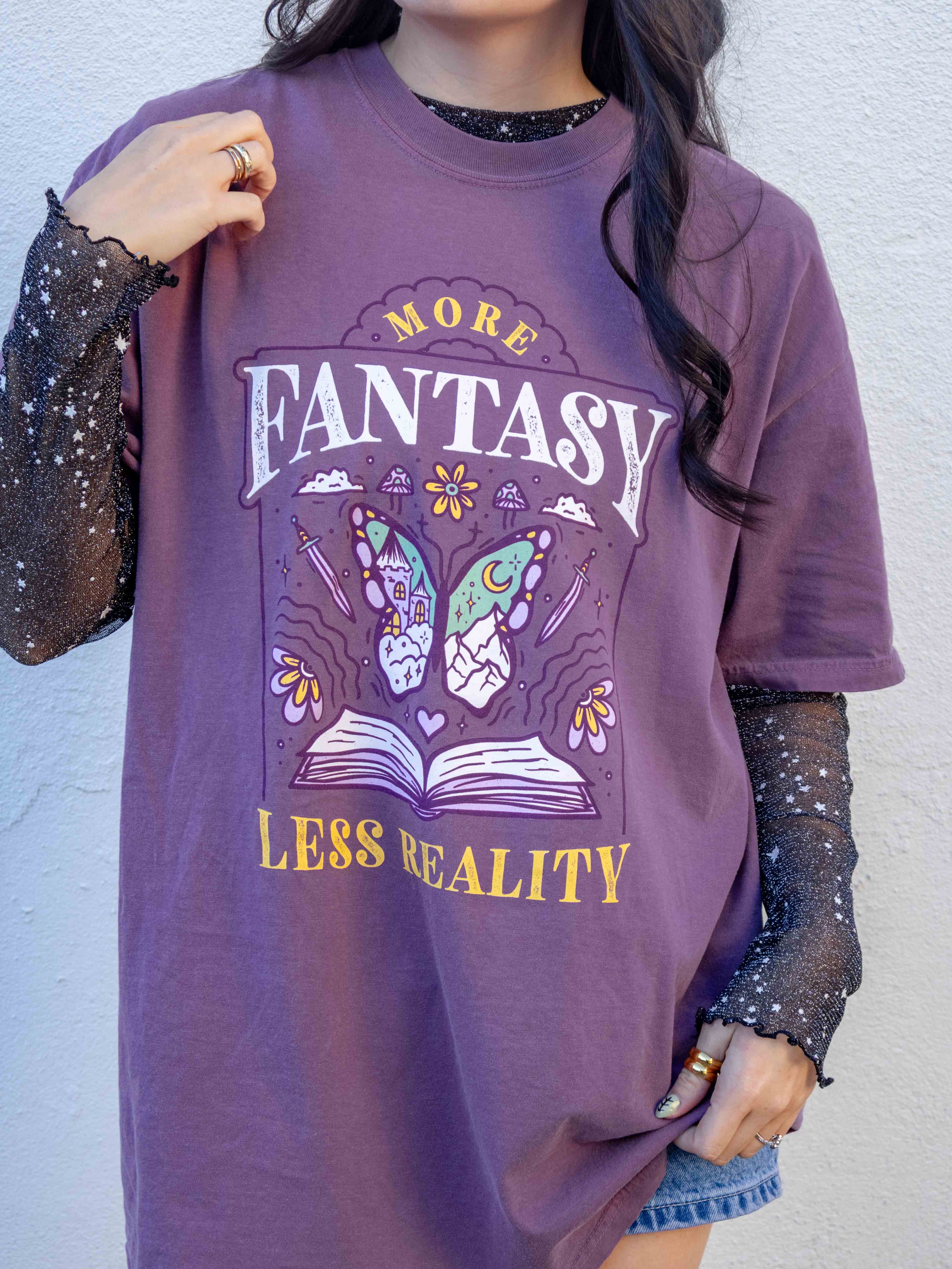 A purple t-shirt More Fantasy Less Reality, with a bookish graphic, Fantasy Romance merch, Gift for readers