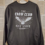 a crow club sweatshirt hung up
