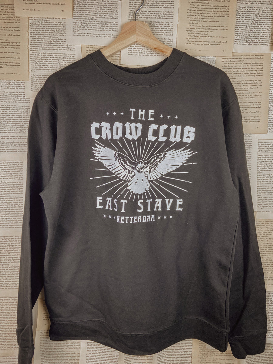 a crow club sweatshirt hung up